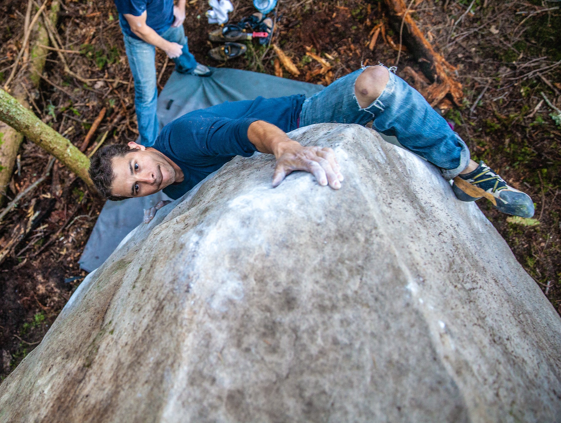 Figure 1: A climber bounce-testing while leading an aid pitch. Note the aider and daisy setup. If her top pieces passes the test, she