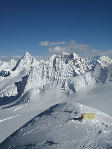 Camp on the East Ridge of Nenang, with Camp on the East Ridge of Nenang, with a wilderness of unclimbed peaks beyond.