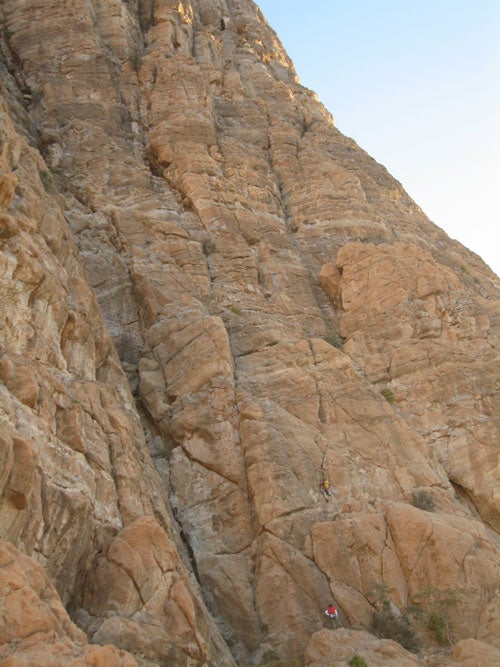 Zoe Hart begins the upper third of Crac Zoe Hart begins the upper third of Cracker Pterodactyl 5000 (VI 5.10+) on Jebel Misht in Oman. The four-person American team bivied on a large ledge…