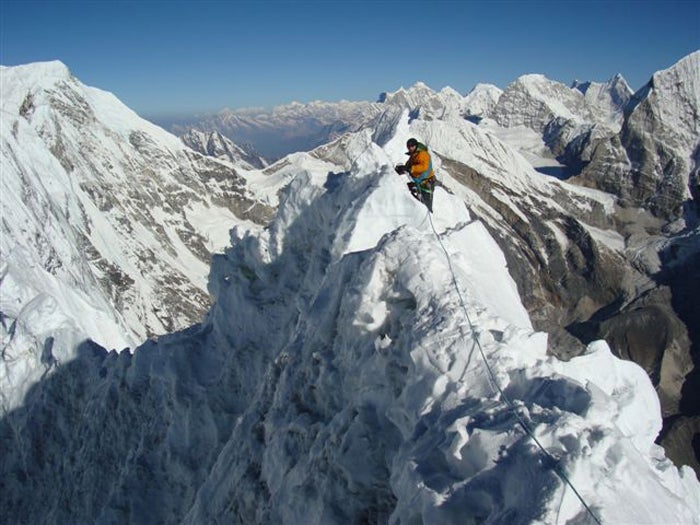 Ueli Steck traverses the corniced summi Ueli Steck traverses the corniced summit ridge of Tengkangpoche. Although the peak had been climbed, no team had ever reached the summit via the…