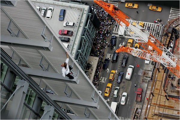 Robert rests on a beam part-way up the Robert rests on a beam part-way up the 52-story ladder. Photo by David Scull/The New York Times.