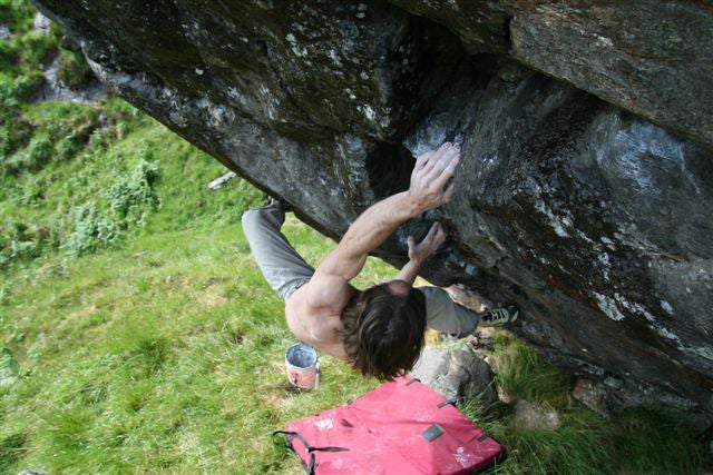 Ty Landman on the Swiss problem Practic Ty Landman on the Swiss problem Practice of the Wild (V15). Courtesy of Moonclimbing.com.