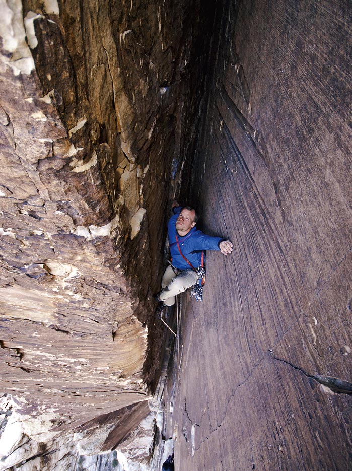 Marc Horan gets his bearings deep in th Marc Horan gets his bearings deep in the climber-swallowing chimneys of Epinephrine (IV 5.9), Black Velvet Canyon, Red Rock National Conservation…