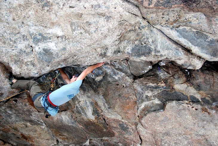 Jason Haas begins the crux sequence of Jason Haas begins the crux sequence of Comprometido (5.14a) in Colorado's South Platte. Photo by Ben Schneider.