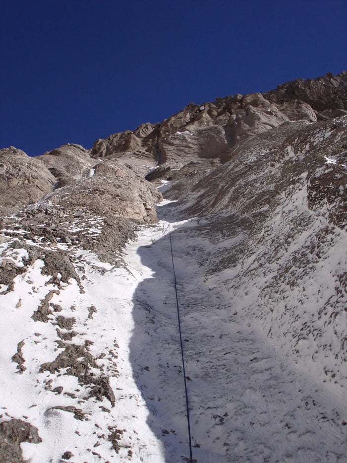 Rappel-downclimbing low on the route to Rappel-downclimbing low on the route to reach the main gully system. Photo by Chad Kellogg