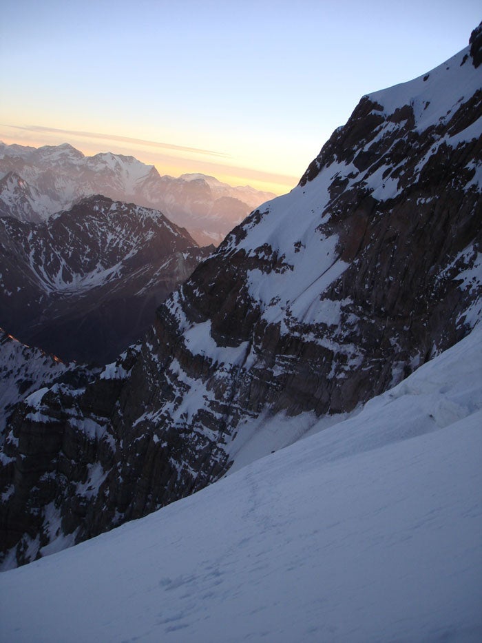 Traversing toward the Messner Route abo Traversing toward the Messner Route above 6,000 meters in early evening on the first day. Photo by Chad Kellogg.