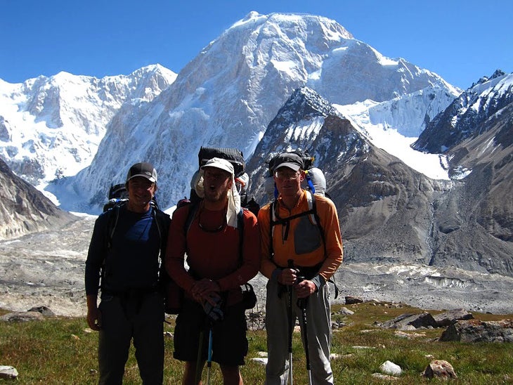 PHOTO: Jed Brown, Kyle Dempster, and Br PHOTO: Jed Brown, Kyle Dempster, and Bruce Normand in front of the north face of Xuelian West in China. Courtesy of Jed Brown.