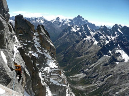 Chad Kellogg traversing below the genda Chad Kellogg traversing below the gendarmes high on Seerdengpu's northeast ridge, with Siguniang (6,250m) prominent in the background. Photo by Dylan…
