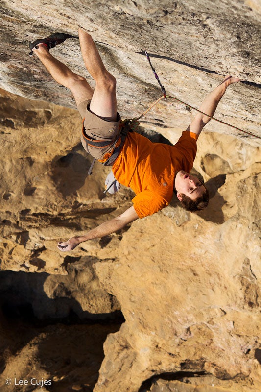 Pringle on a one-footed bat hang ten fe Pringle on a one-footed bat hang ten feet below the first crux. Photo by Lee Cujes