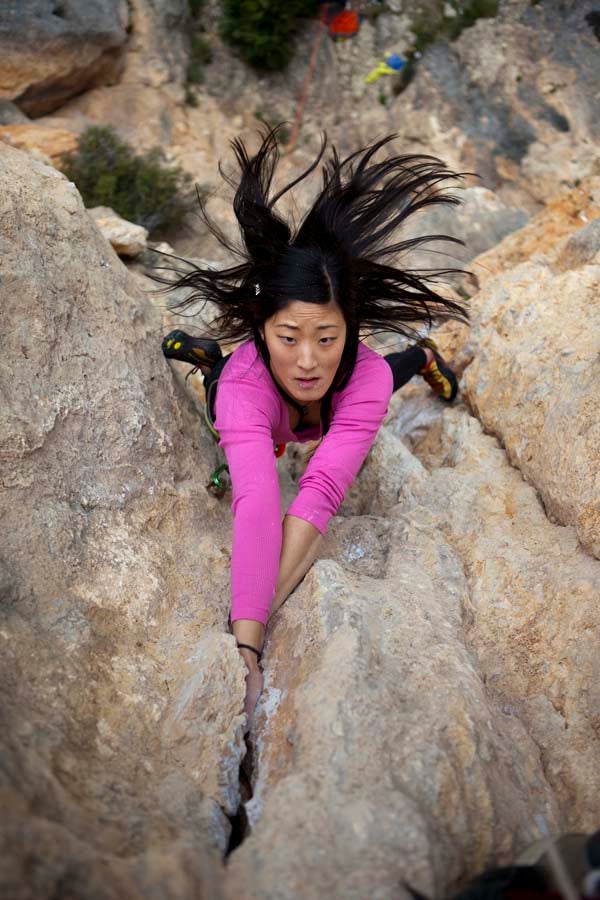 Burr2010_7_1143.jpg Jules Cho gets into the Costa Blanca Tufa Groove (5.11a), Olta, Spain. From Climbing no. 286 - June 2010 - Photo Annual