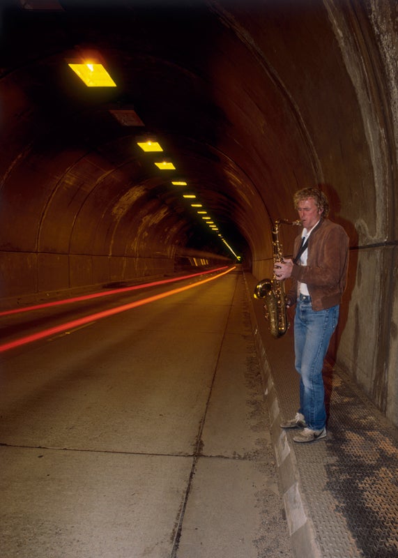 SaxintheTunnel_4894.jpg John loved the reverb effect in the tunnel near his house in Foresta. 1985 for Outside Magazine. Photo by Phil Bard / www.philbard.com
