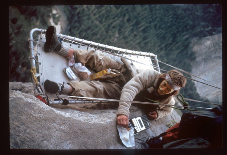 Bill Westbay eating a meal on a portaledge while climbing the Zodiac, in Yosemite