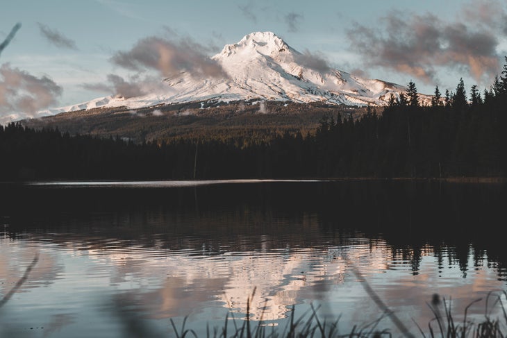 Mount Hood_dave-herring-1499667-unsplash Mount Hood in the distance. Timothy Lake sits in the foreground with a reflection of the sky and trees on the water.