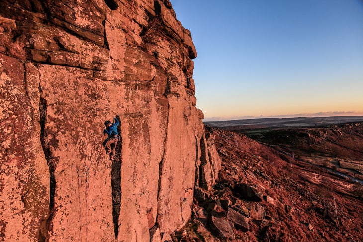 _MG_2316_Curbar_E9_2 A man climbing above a nest of gear on gritstone