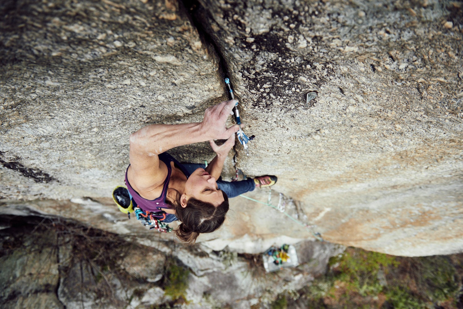 Female climber places a micro cam while leading a crack climb