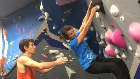Dierdre Wolownick bouldering at the Central Rock Gym, NYC, with Alex Honnold spotting. Says Wolownick, "I always climb my best when I know Alex has my back."
