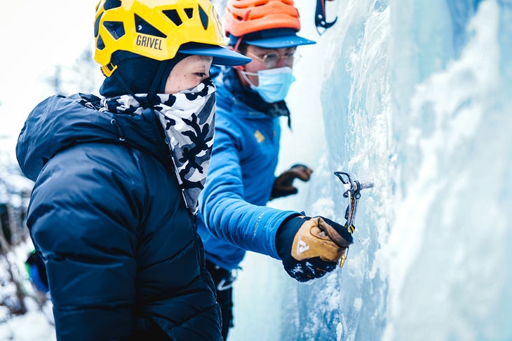 Don Nguyen aids Michelle Lin in a detailed instruction about placing ice screws.