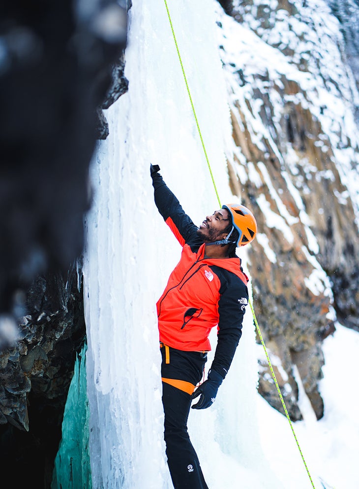 Fred Campbell, a climbing guide for Climbers of Color, instructing on ice tool placement. 