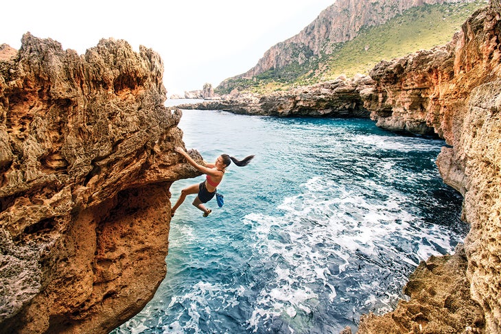 Rock climbing on coast of Sicily.