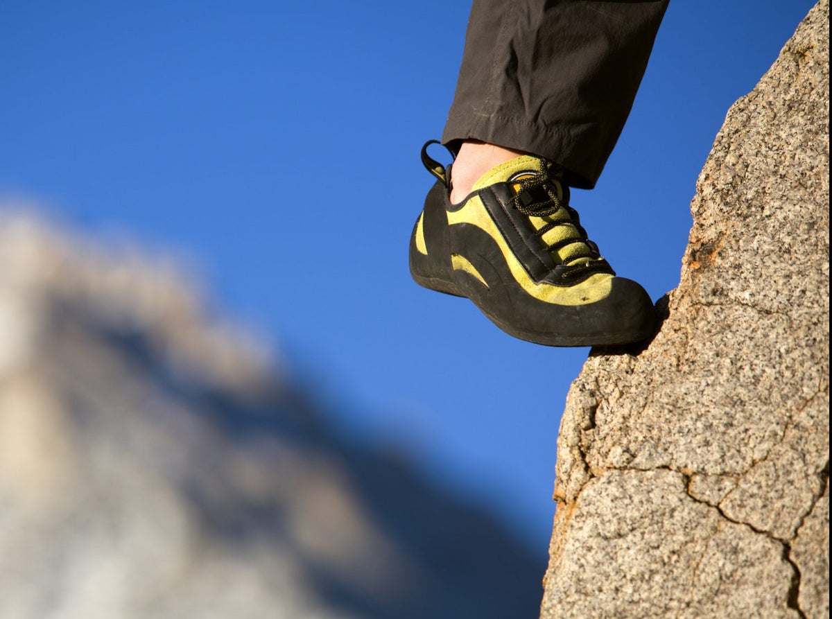 A climber's foot in a shoe on a foothold Climbing