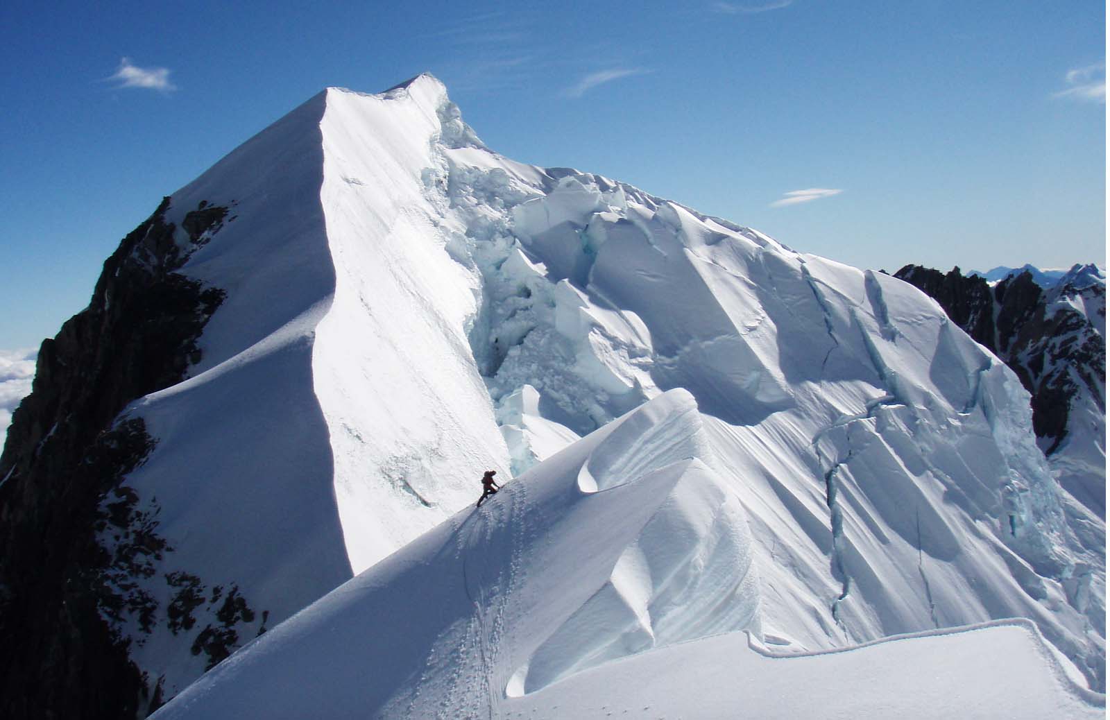 Cook paying homage to the great Mt. Tasman, New Zealand, with Mt. Lendenfeld in the background. She’s actually removing a snow picket used for running pro.