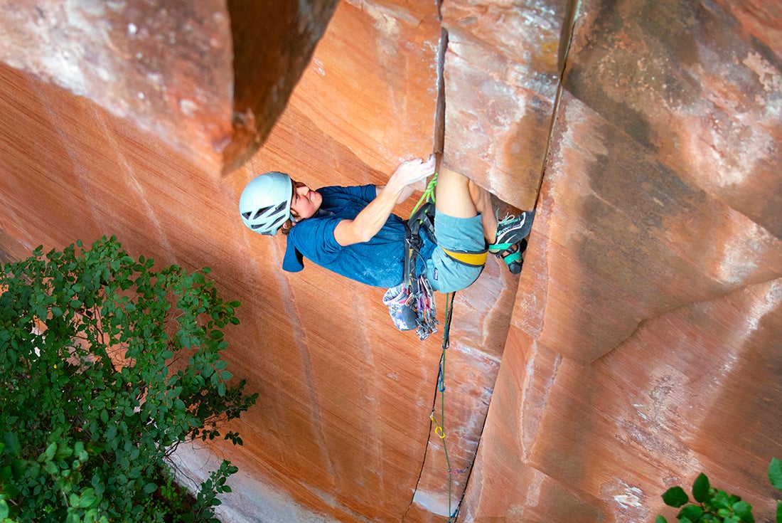 Climber high on a red-rock face