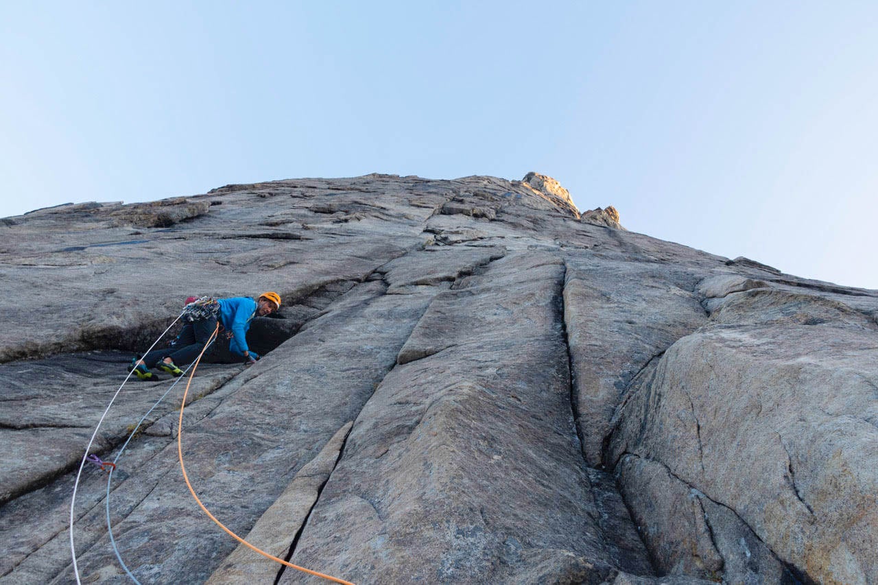 Rock climber on remote big wall in Greeland.