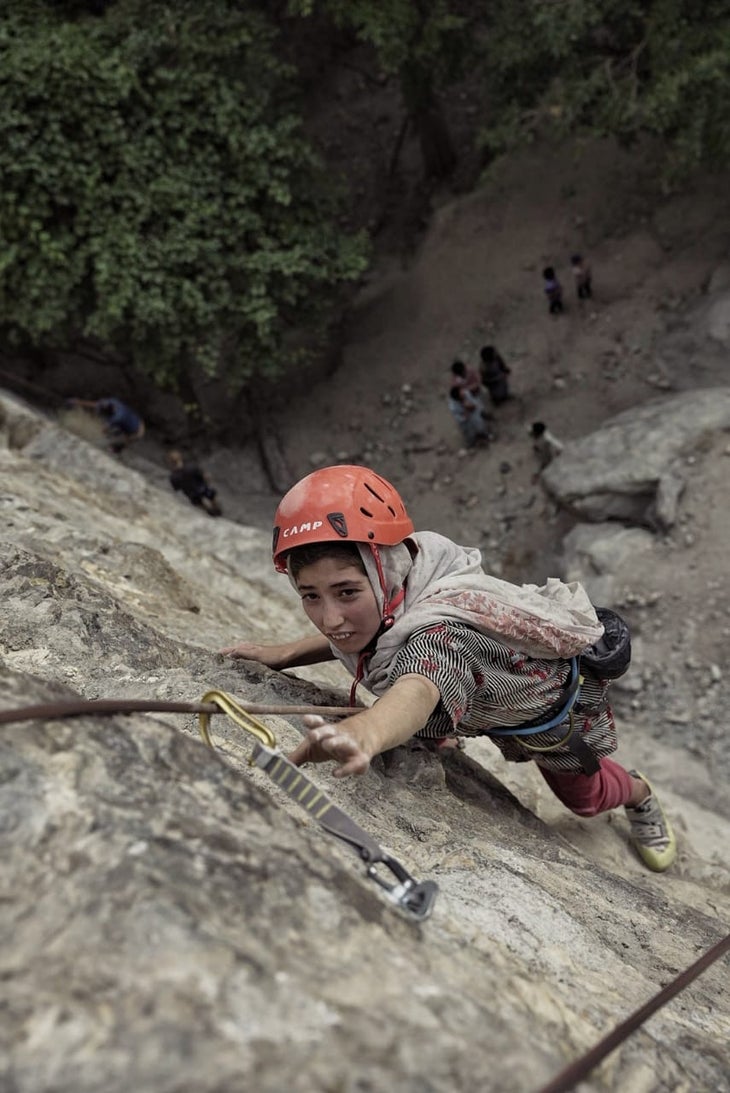 A Pakistani girl topropes a new route near her home in Shigar Valley