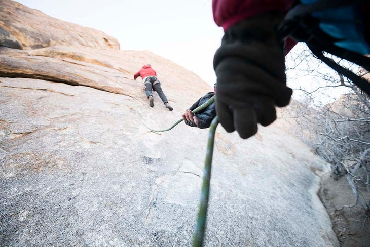 A climber belaying another climber on lead.