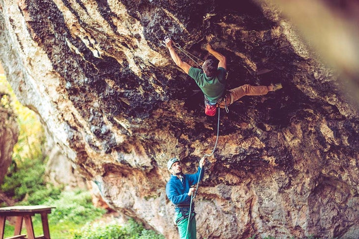 Climber leading rock route.