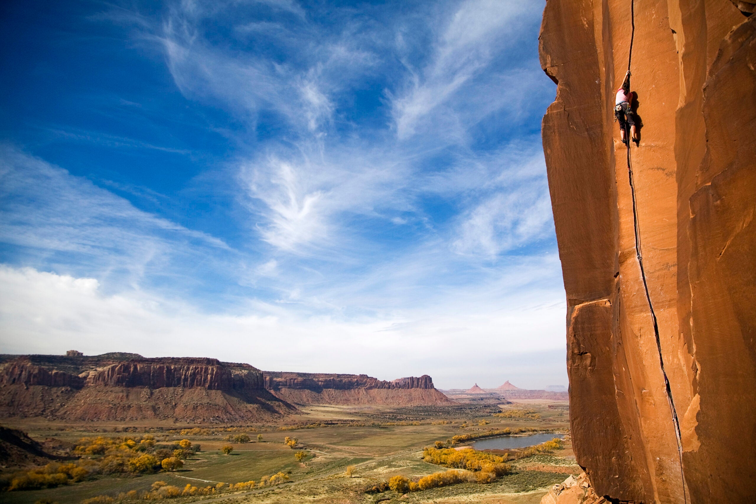 A female rock climber climbs the classic route called Scarface, rated 5