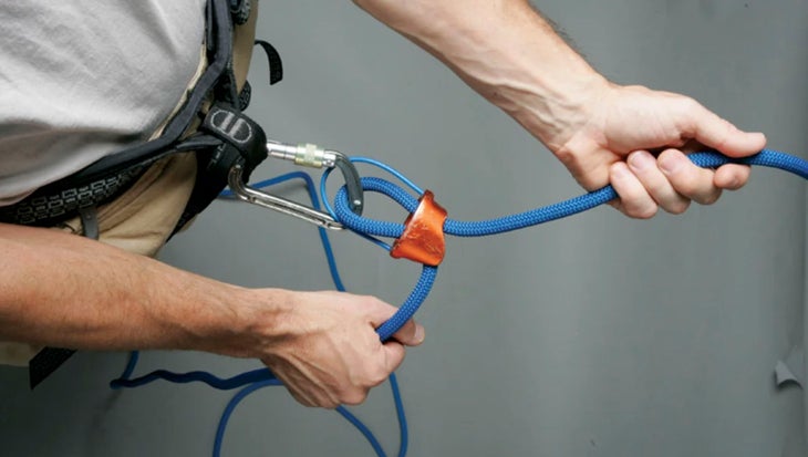 Belaying rock climber with an ATC.