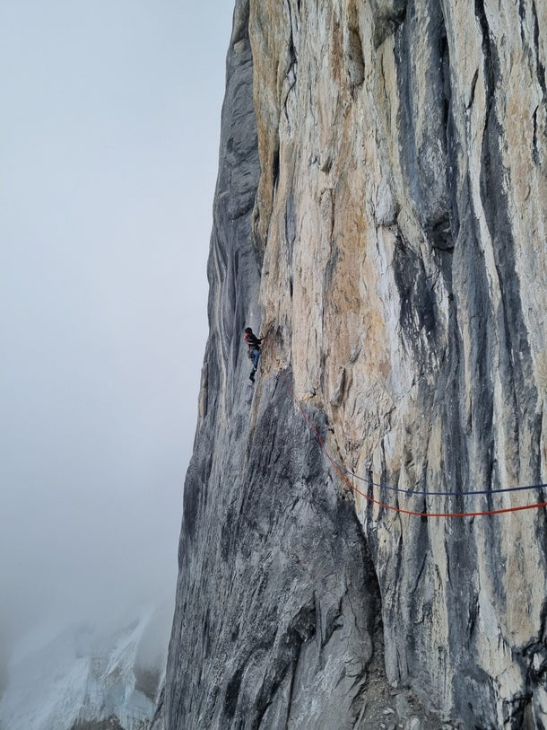 Climbing rock on Siula Grande, Peru.