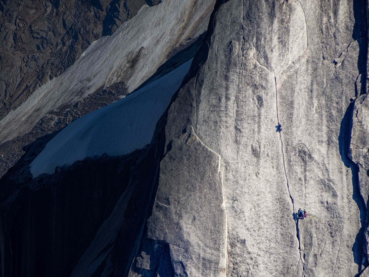 Climbers ascend granite peak in Canada.