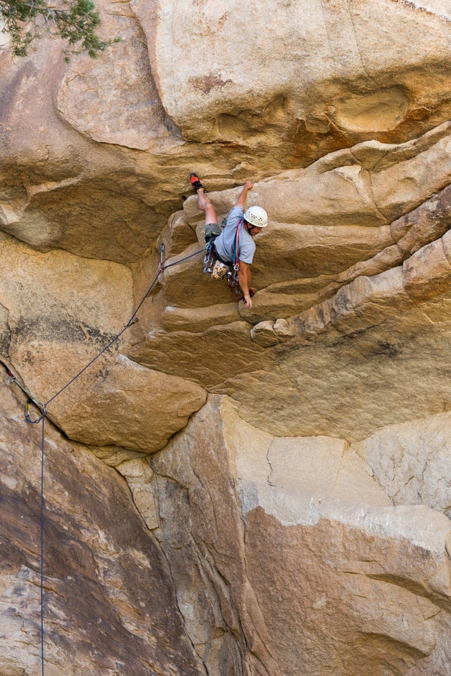 Climbing steep sport climb in Joshua Tree, California.
