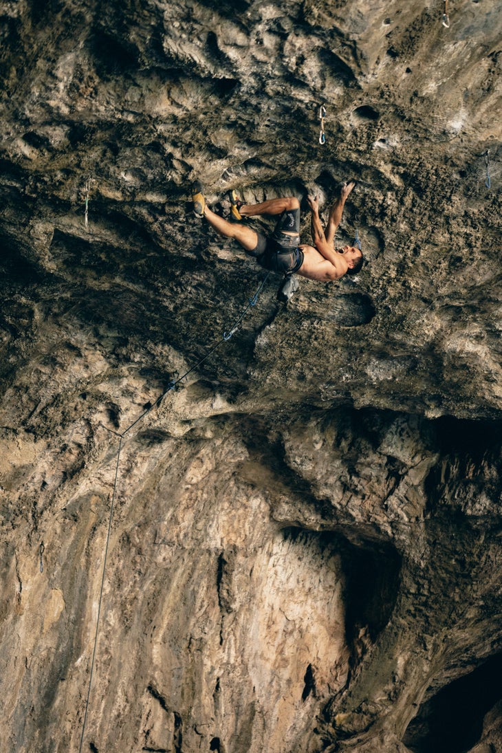 Siegrist climbing the steep lower part of the climb. He's back-flagging his right leg and crossing right handed up into a crimp.
