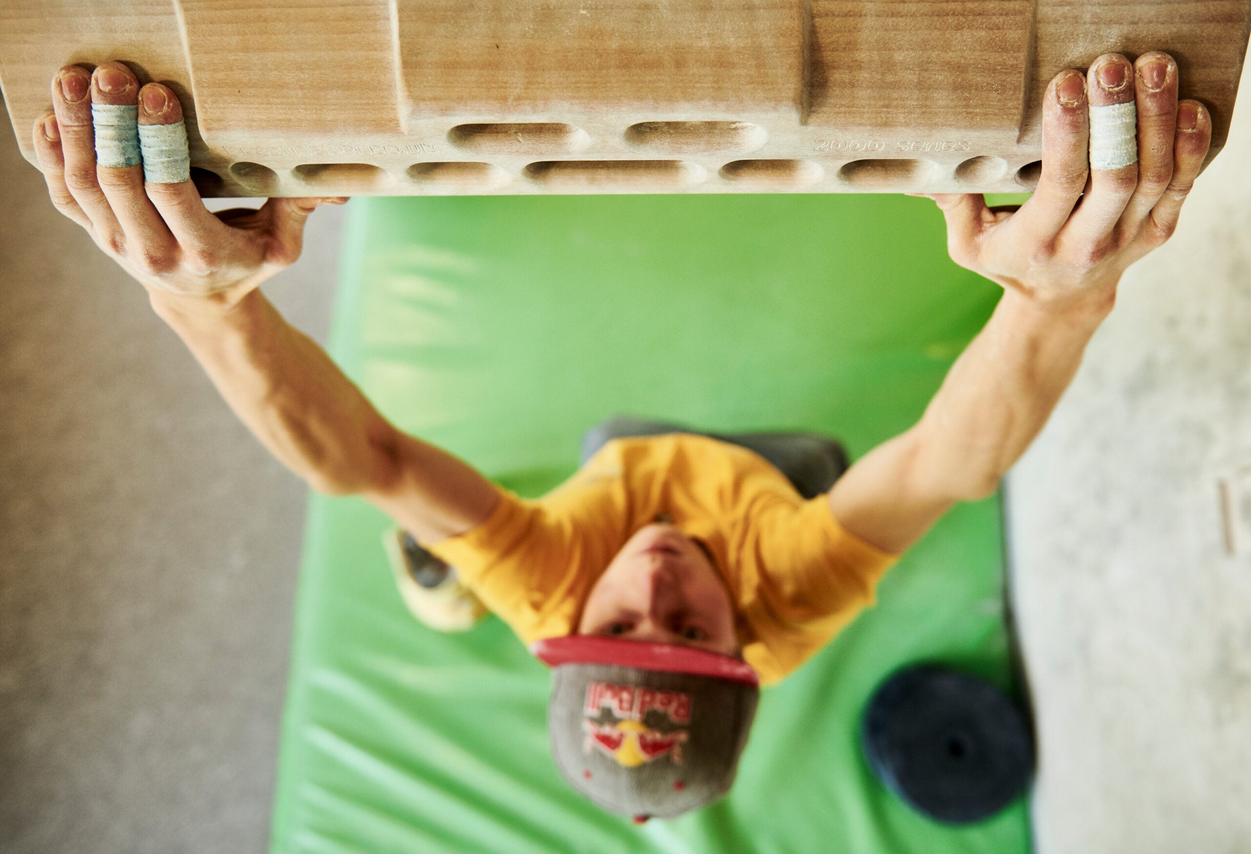 Rock climber Alex Megos training on hangboard.