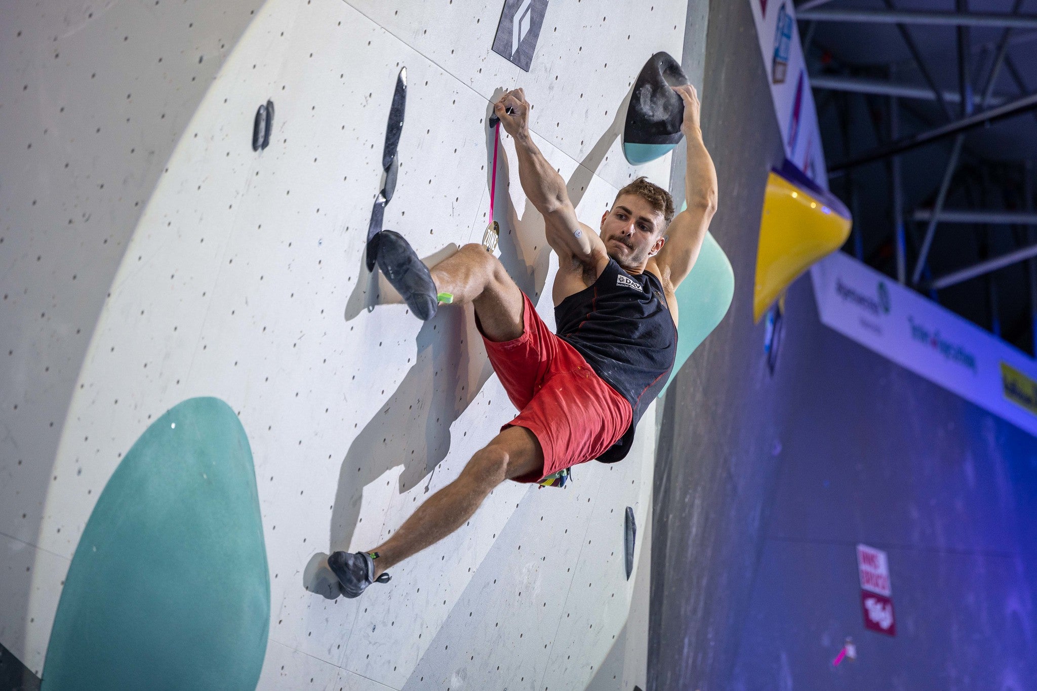 Pro climber Yannick Floe of Germany executes an outside edge/step through move at the Boulder finals during a World Cup competition in Innsbruck in 2022.