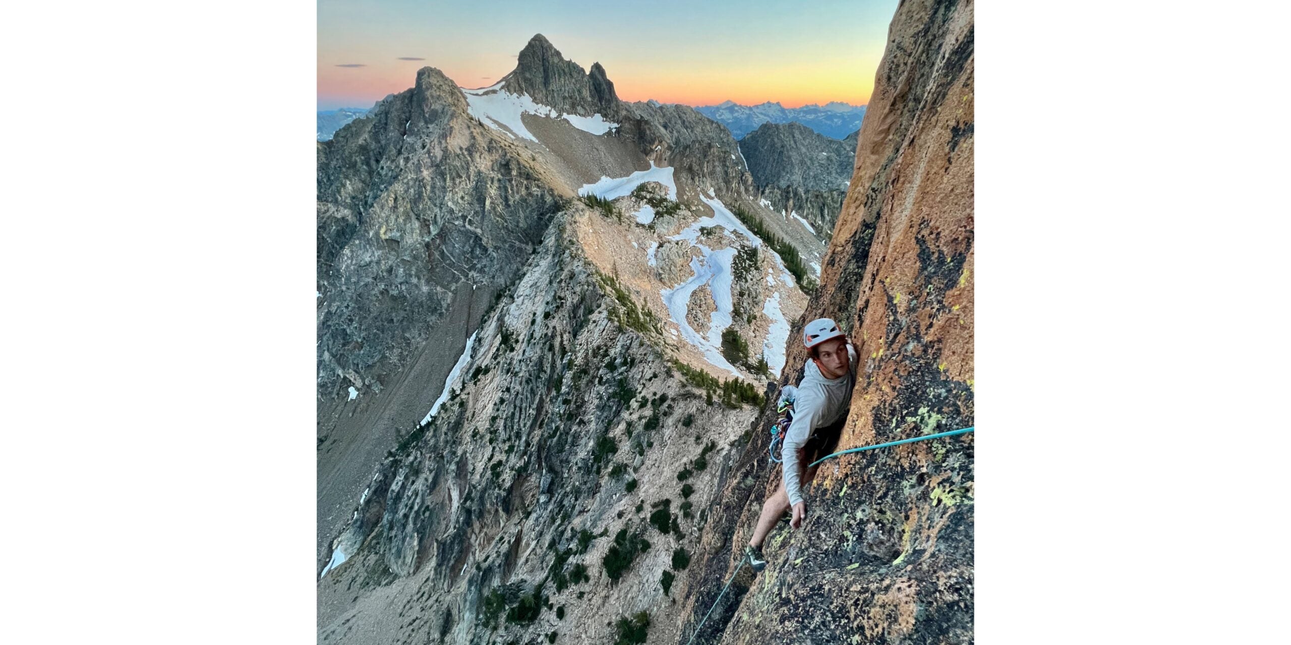Rock climber top ropes pitch high in Washington Pass alpine