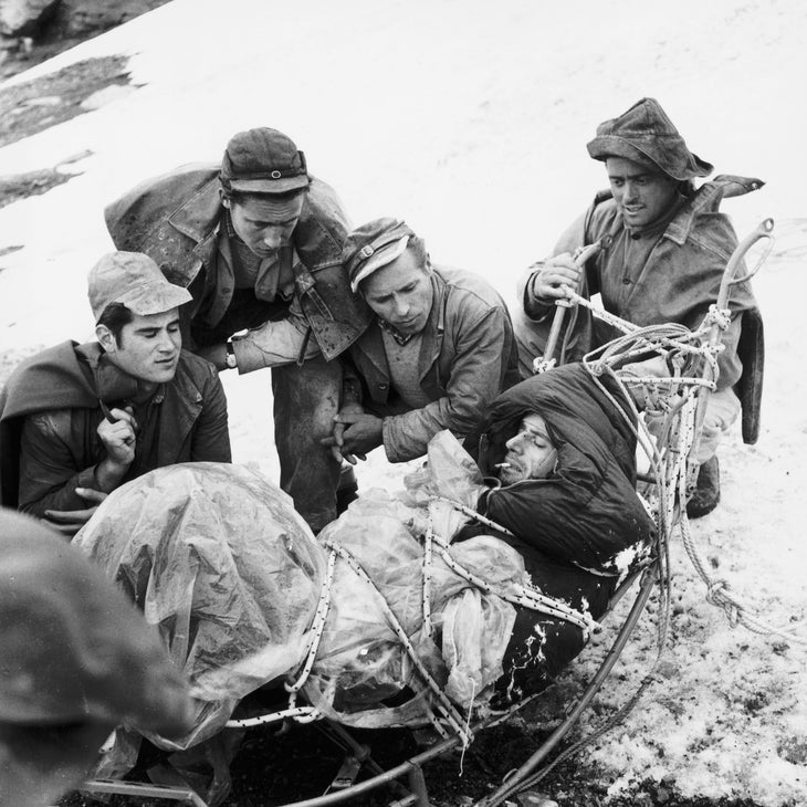 Climber Claudio Corti being carried in a stretcher off the Eiger mountain.