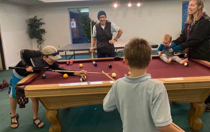 Rock Climber Matt Samet with family playing pool.