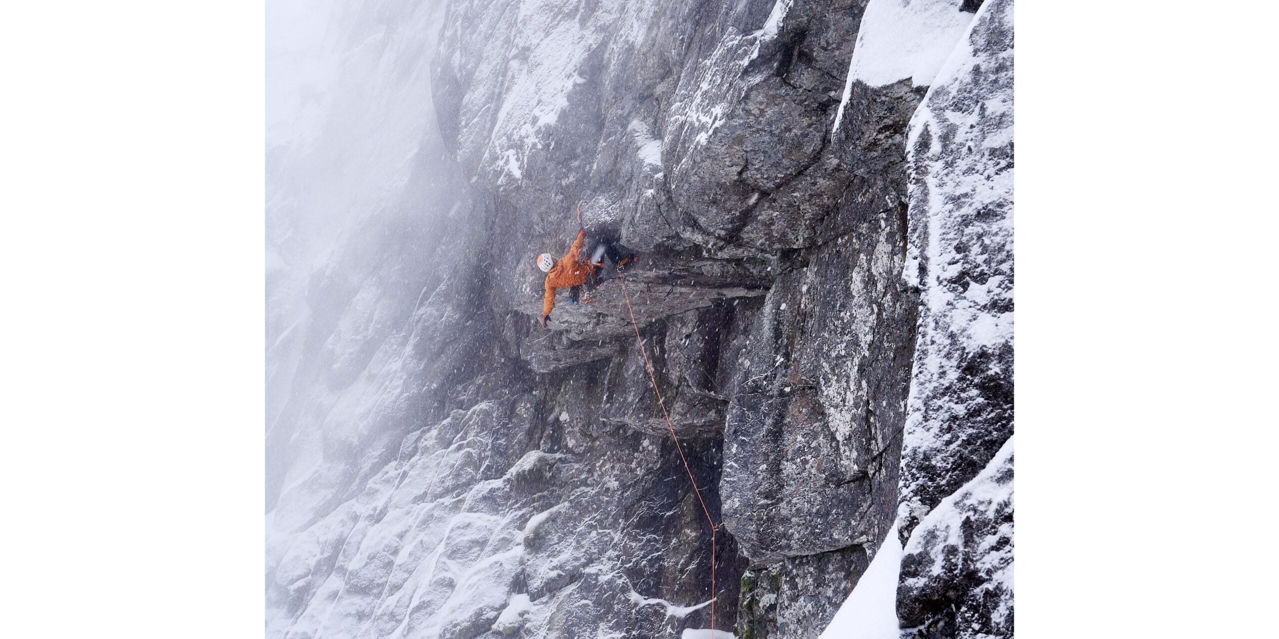 Greg Boswell climbs steep roof crack with ice tools and crampons.