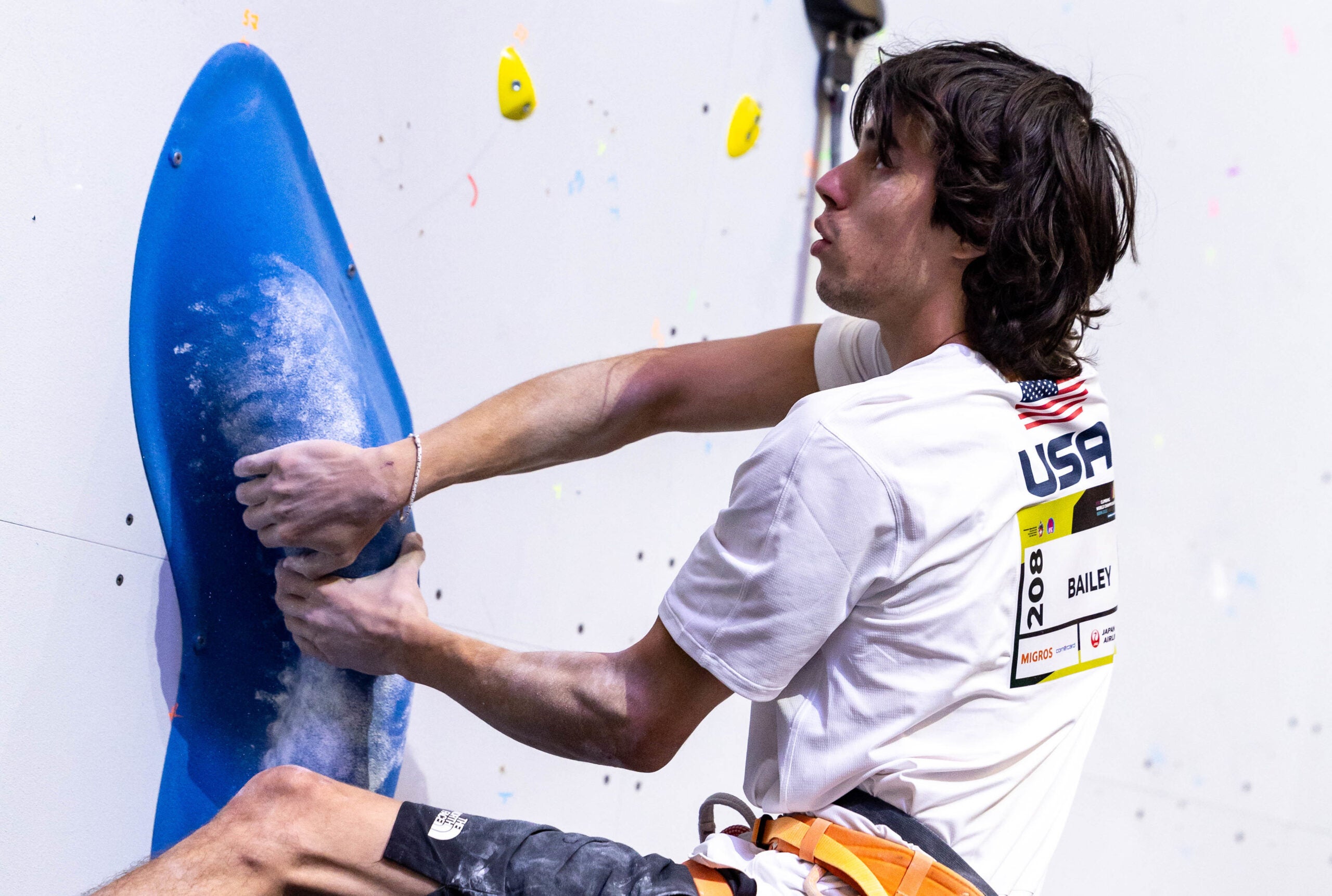 A man sport climbing in competition