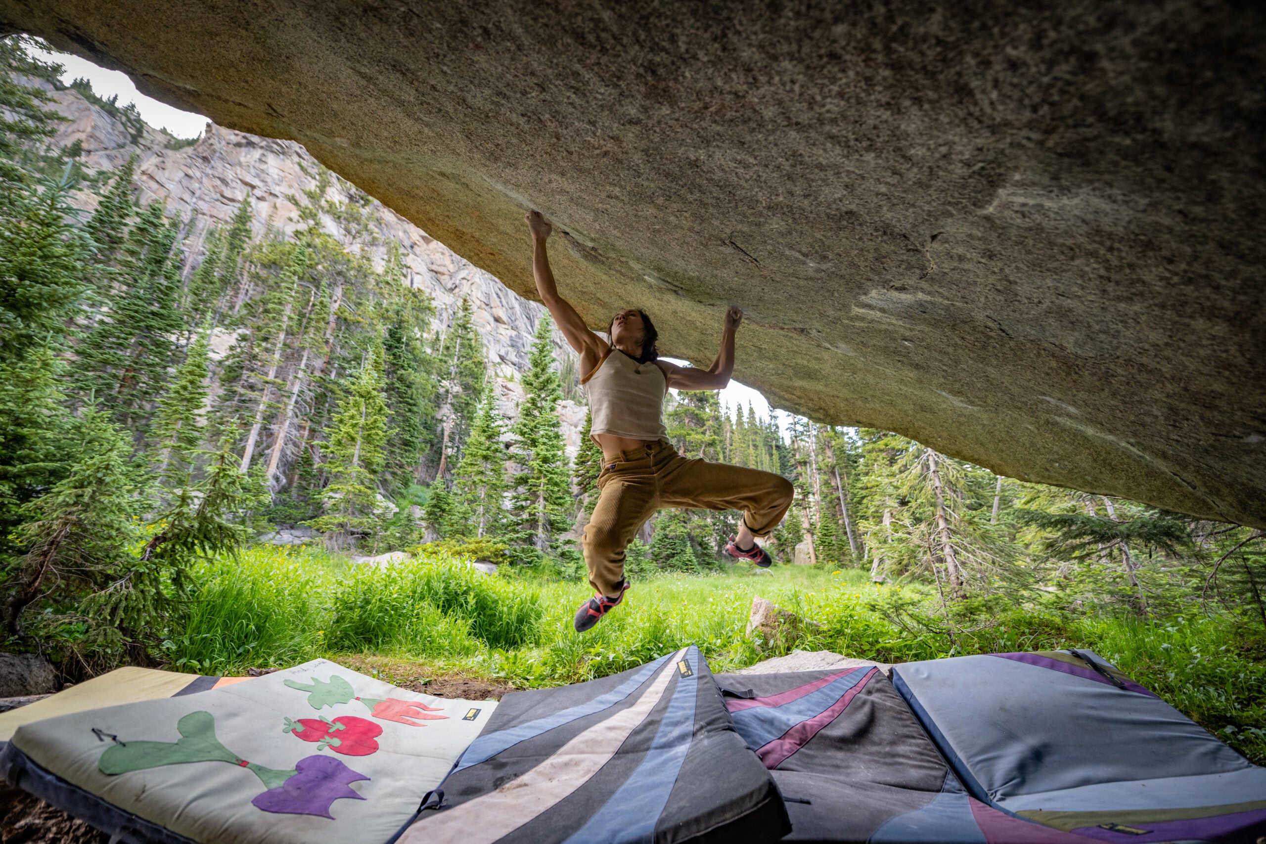 Katie Lamb cutting feet on Box Therapy, V16. Shot from the inside of the boulder, underneath it.