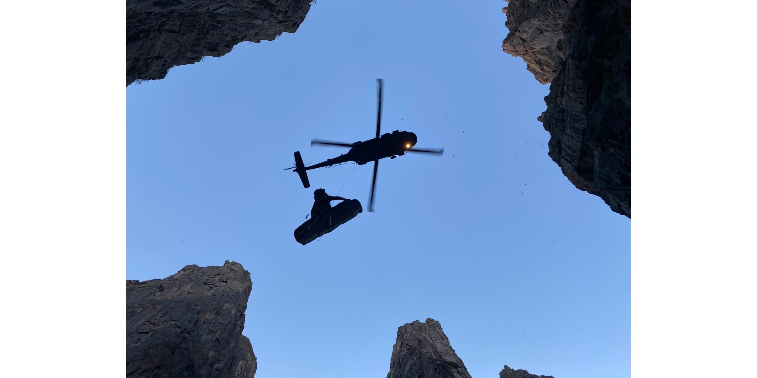 An injured climber and a HAATS flight tech get hauled up into the Black Hawk helicopter at the conclusion of an extremely complex and daring rescue.