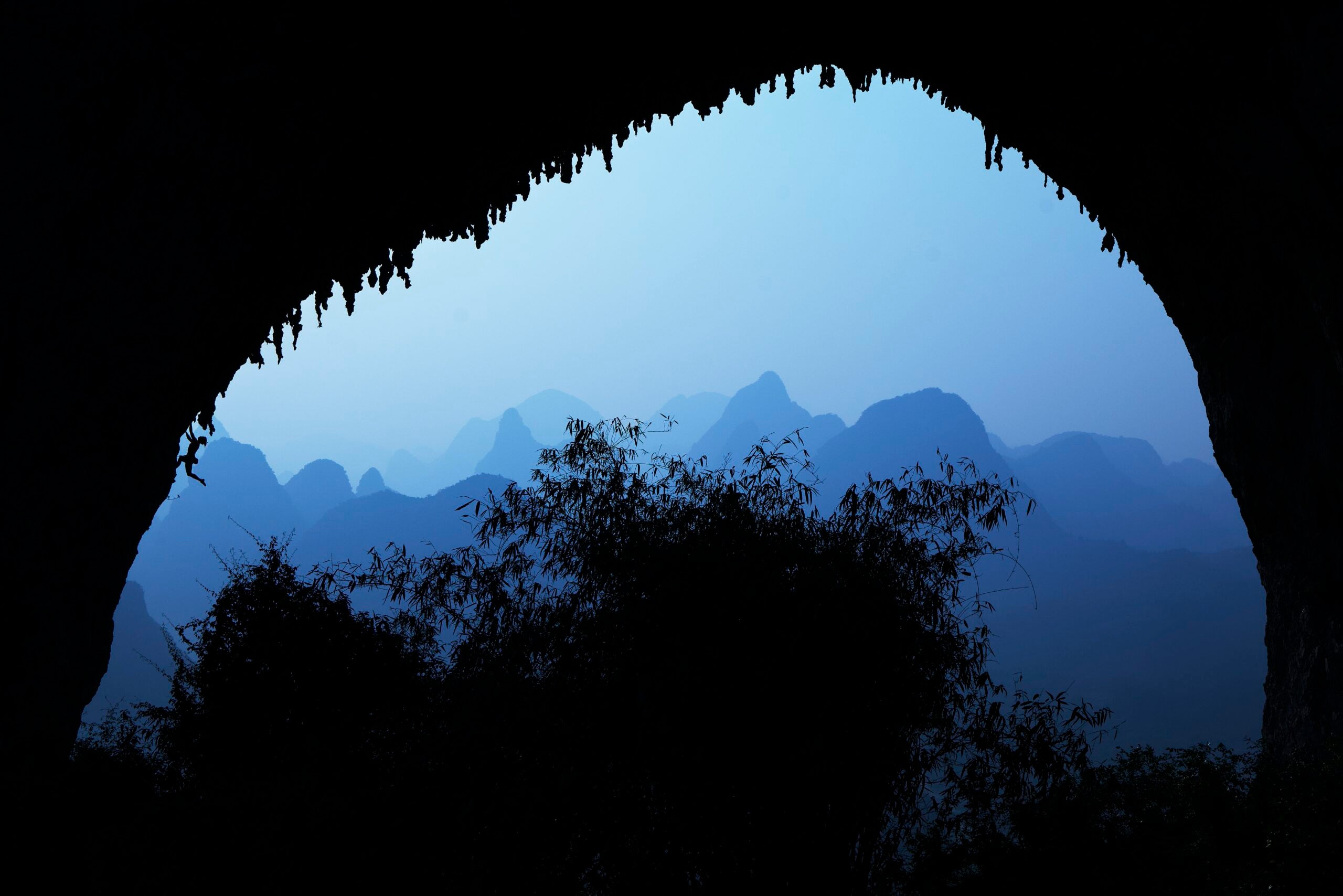 astrology for climbers: a woman climbs at dusk