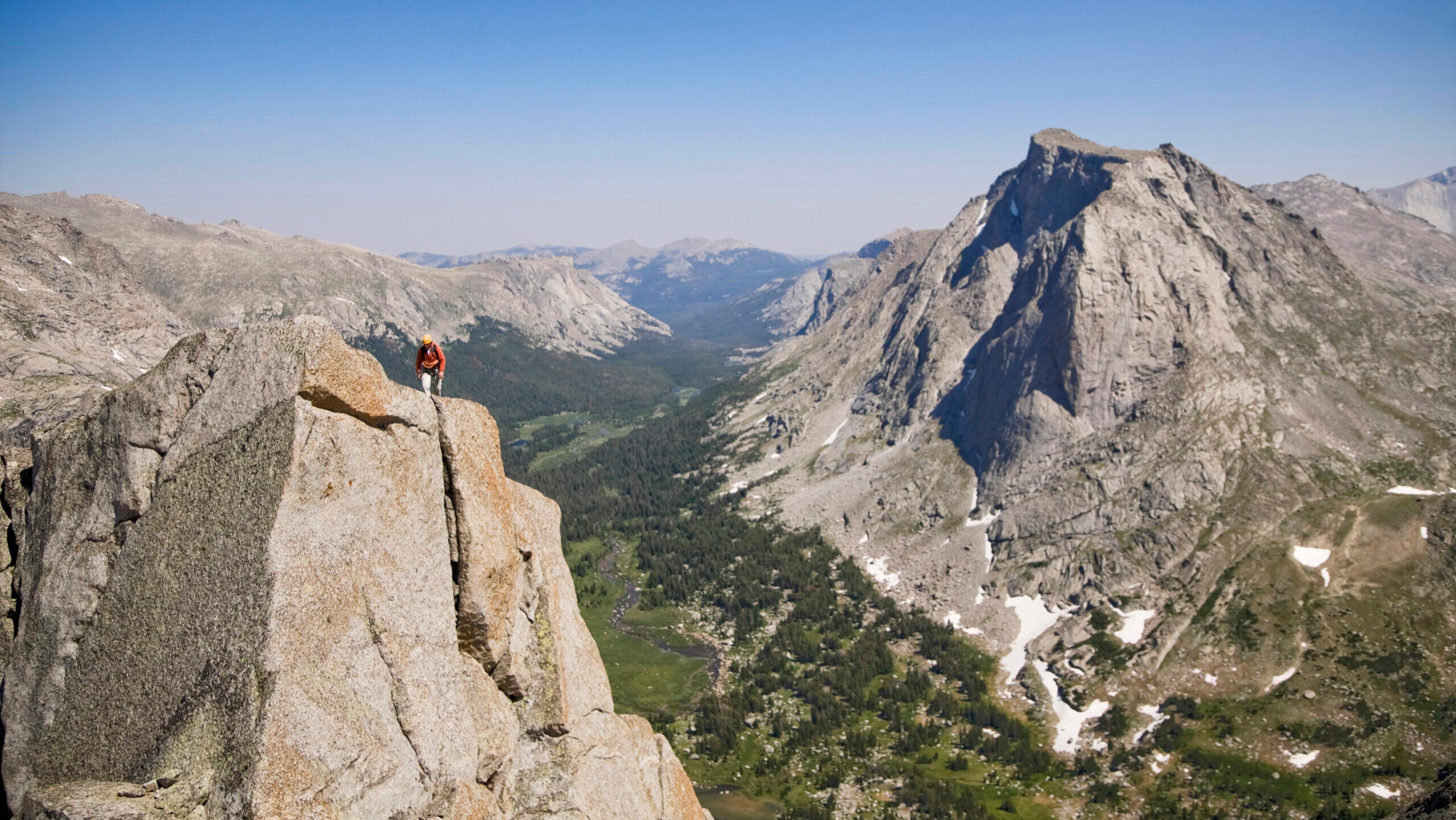 A male rock climber ascends the 50's classic route, the Northeast Face of Pingora in the Cirque of the Towers, Wind River Range, Wyoming.
