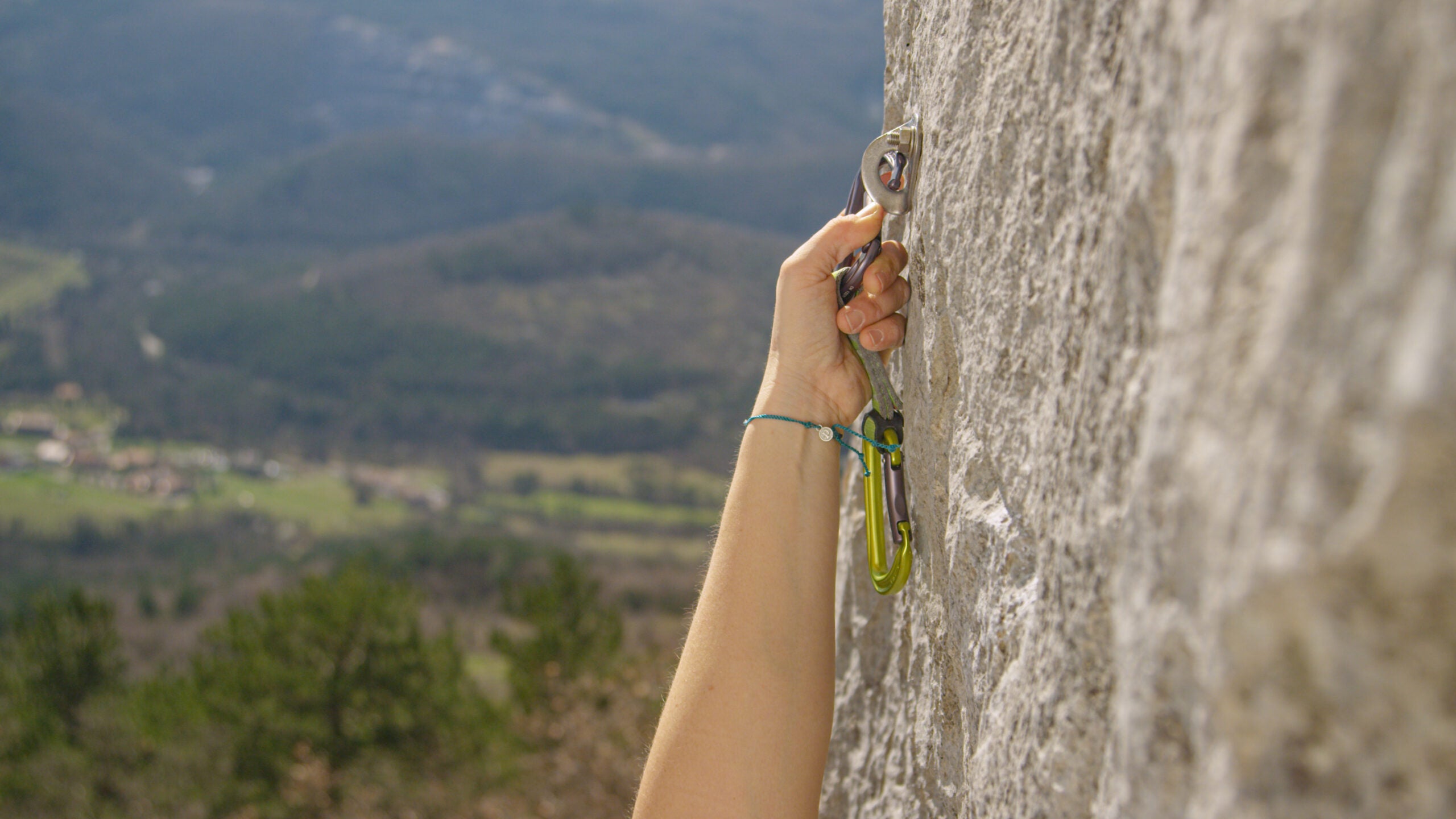 a hand clipped a quickdraw to a bolt on rock. but is it facing the right way?