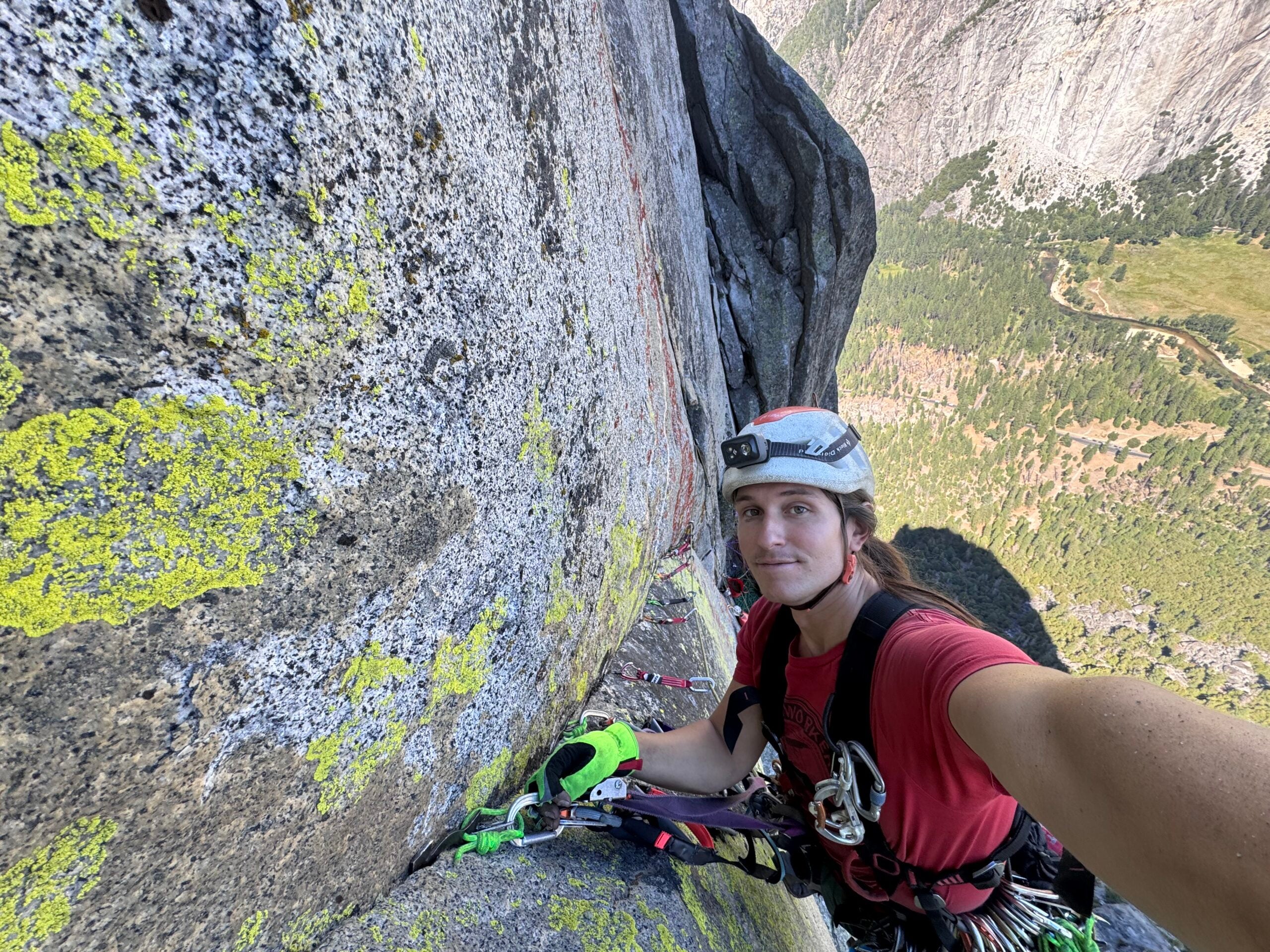 Taylor Martin pauses on a beak seam midway up their 1600-foot A4 first ascent, 'Hummingbird,' in Yosemite Valley.