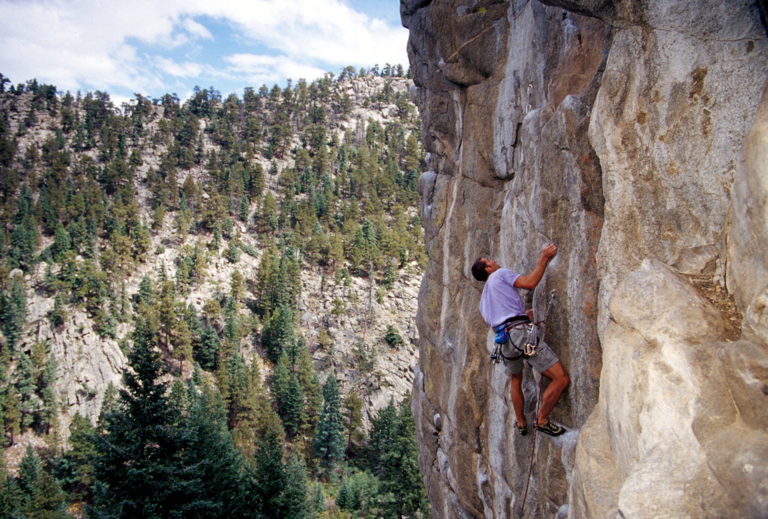 A man climbing Easter rock in Boulder Canyon. The least sandbagged climbing areas include Boulder Canyon, Indian Creek, Red River Gorge, Moe's Valley, Ten Sleep, Kalymnos, Rocklands